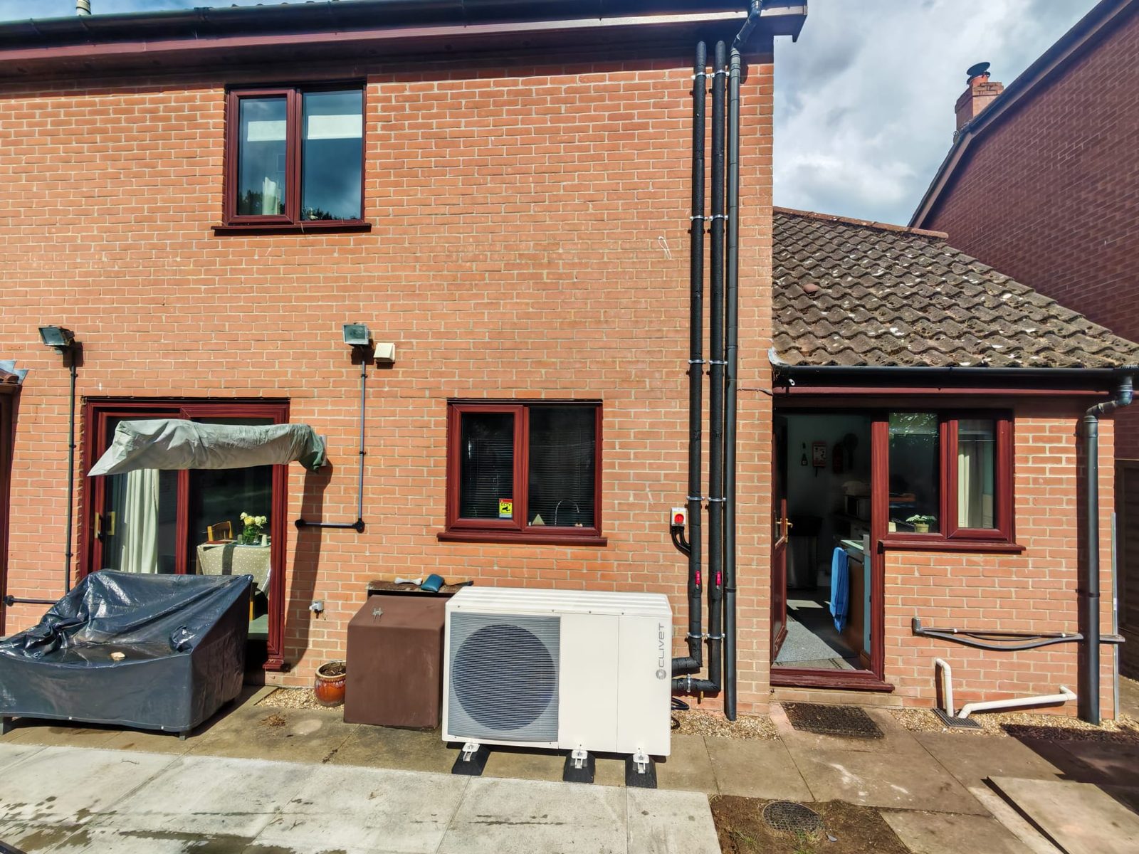 Air source heat pump installed at a red-brick Suffolk home